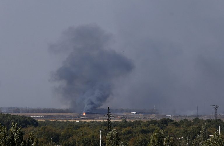 A smoke rises after shelling in the town of Donetsk, eastern Ukraine, Saturday, Sept. 20, 2014. Negotiators in Ukrainian peace talks agreed early Saturday to create a buffer zone to separate government troops and pro-Russian militants and withdraw heavy weapons and foreign fighters in order to ensure a stable truce in eastern Ukraine. (AP Photo/Darko Vojinovic)