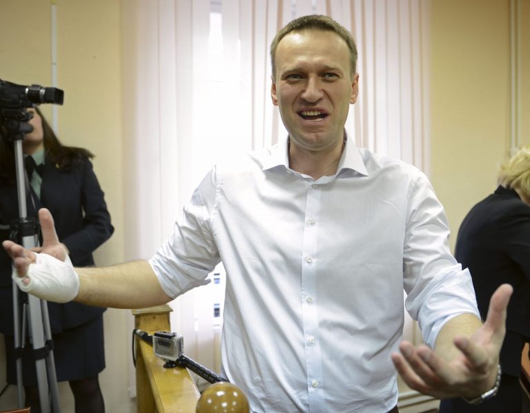 Russian opposition leader Alexei Navalny speaks to journalists after a trial in Kirov, Russia, Wednesday, April 17, 2013. The trial of Navalny accused of embezzling half a million dollars' worth of timber from a state-run company was adjourned shortly after its start Wednesday in the northwestern city. (AP Photo/Mitya Aleshkovskiy)