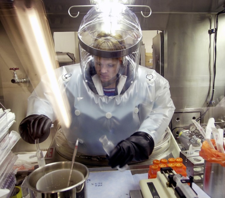 In this May 11, 2003, file photo, Microbiologist Ruth Bryan works with BG nerve agent simulant in Class III Glove Box in the Life Sciences Test Facility at Dugway Proving Ground, Utah. (AP Photo/Douglas C. Pizac, File)