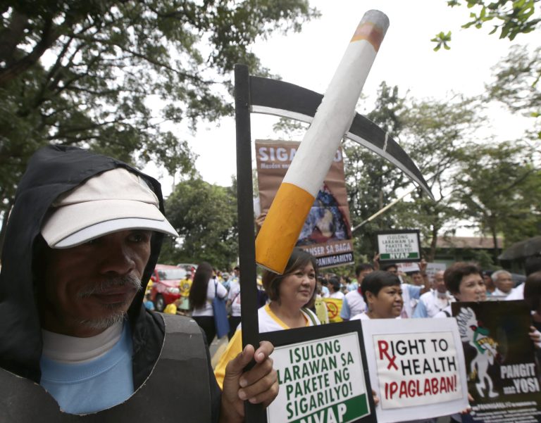 FILE - In this Jan. 17, 2014 file photo, health advocates, including cancer survivors, gather for a rally outside the Commission on Human Rights office at suburban Quezon city, northeast of Manila, Philippines to push for the inclusion of a legislative measure that will mandate tobacco firms to put graphic health warnings on cigarette packs. A Philippine legislative committee approved a bill on Tuesday, June 10, 2014 that would compel cigarette manufacturers to print illustrations of smoking hazards on cigarette packs to curb smoking in a country where tens of thousands die yearly from tobacco-related diseases. (AP Photo/Bullit Marquez, File)