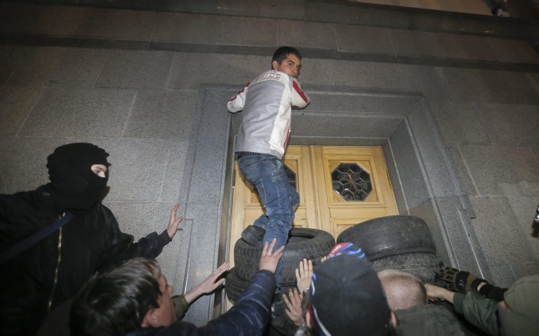 Members of the right wing ultra nationalist Right Sector group block the parliament building in Kiev, Ukraine, Thursday, March 27, 2014. Activists demanded the resignation of the Interior Minister following the recent killing of a Right Sector member Oleksandr Muzychko, who was died during a police operation to detain him. (AP Photo/Efrem Lukatsky)