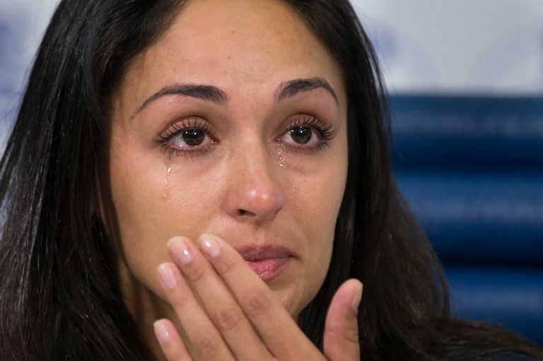 Anna Otisko, the girlfriend of Roman Seleznev, a Russian man who was arrested on bank fraud and other charges earlier this week in the United States, cries as she listens to a question during a news conference in Moscow, Russia, Friday, July 11, 2014. Family members of a Russian man charged with hacking in the United States insist he is innocent and fear incarceration will kill him. (AP Photo/Alexander Zemlianichenko)