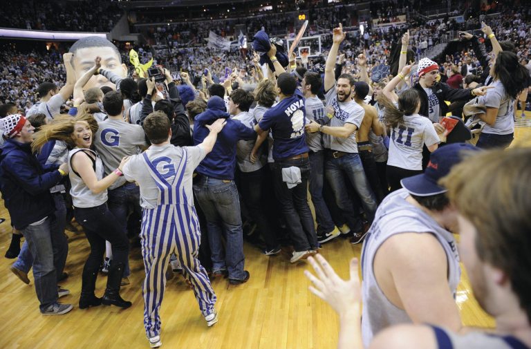 Nick Wass/AP
Georgetown fans overturned tables and chairs to rush the floor after the Hoyas beat Syracuse.