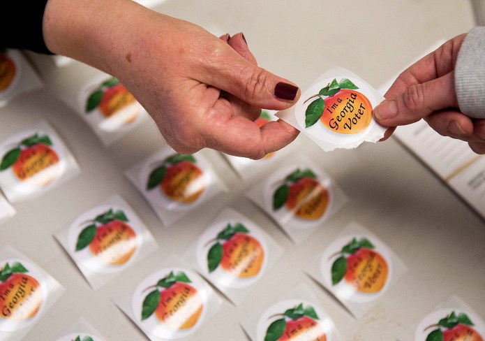 A 2010 policy implemented by Georgia Secretary of State Brian Kemp, who was named as the defendant in the lawsuit, prevents Georgia citizens from being added to the voter rolls unless all identifying information on their voter registration application exactly matches information in certain state databases. (AP Photo/David Goldman)