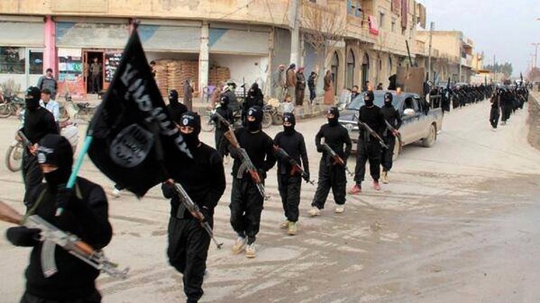 FILE - This undated file image posted on a militant website on Tuesday, Jan. 14, 2014, which has been verified and is consistent with other AP reporting, shows fighters from the al-Qaida linked Islamic State of Iraq and the Levant (ISIL) marching in Raqqa, Syria. Across the broad swath of territory it controls from northern Syria through northern and western Iraq, the extremist group known as the Islamic State has proven to be highly organized governors.