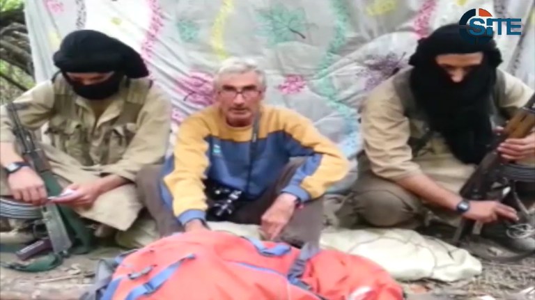 In this still image from video published on the Internet on Monday, Sept. 22, 2014, by a group calling itself Jund al-Khilafah, or Soldiers of the Caliphate, a captive Frenchman appeals to French President Francois Hollande to help free him. The Frenchman, whom the ministry described as a 55-year-old mountain guide, said he was taken hostage by the group on Sunday and reiterated its demands that the French military end its airstrikes in Iraq. The group said it was answering a call by Islamic State group spokesman Abu Muhammad al-Adnani to attack Americans and Europeans. (AP Photo)