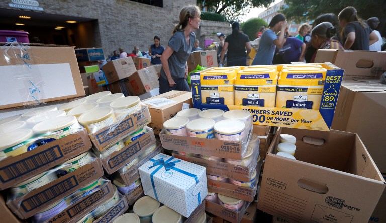 In this 2017 photo, boxes of donated infant formula are stacked by volunteers. The GOP tax overhaul passed by Congress sets a $10,000 limit on the federal deduction for state and local taxes. But it appears that state and local governments could circumvent that limit by setting up charities to fund programs. Taxpayers could donate to the charities and, in return, receive a tax credit applicable to state or local taxes. (AP Photo/Tony Gutierrez)