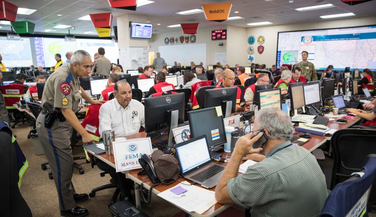 Workers answer calls in the State of Texas Emergency Command Center at Department of Public Safety headquarters in Austin. FEMA's deputy associate administrator for insurance and mitigation said there have been reports of a robocall intended to extort money out of people whose homes have flooded in the wake of Hurricane Harvey. (Ricardo B. Brazziell /Austin American-Statesman via AP)