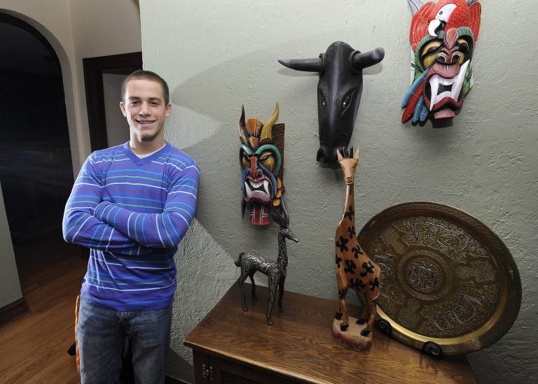   In this Dec. 3, 2012 photo, Alex Baratta, 17, a senior at Hersey High School in Arlington Heights, Ill., poses with some of the works of art that he brought back from his work in Ghana and other places overseas. Baratta spent part of the summer of 2012 in Hohoe, the capital of Ghanaâs mountainous Volta region. He developed lesson plans and taught math and English to young students. He also led a team in creating an educational mural at a community school and volunteered at an orphanage. Alex hopes to one day bring his future engineering expertise to developing countries. (AP Photo/Daily Herald, Mark Welsh) MANDATORY CREDIT, MAGS OUT, TV OUT  
