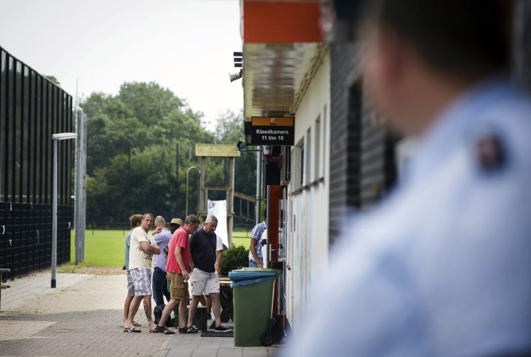 People enter the door to attend a gathering at soccer club Altius in Hilversum, Netherlands, Saturday, July 19, 2014. A family, father, mother, daughter and son, from which the father and the son were members of the club, were among those killed when a Malaysian jetliner was shot down over Ukraine Thursday. All passengers, 298 people from nearly a dozen nations, more than half being Dutch were killed. Across the Netherlands, at sports clubs, schools and churches, friends met Saturday to console each another and attempt to come to terms with their loss. (AP Photo/Phil Nijhuis)