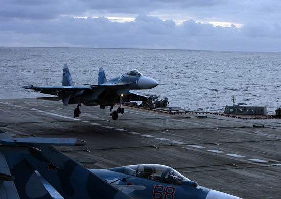 A Russian Su-33 catches the arresting gear aboard the aircraft carrier Admiral Kuznetsov. An Su-33 skidded off the deck of the ship attempting a landing, according to reports. (Russian Defense Ministry)