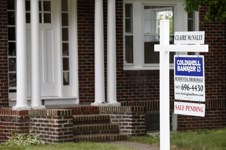 This July 10, 2014 photo shows a house with sale pending sign in Quincy, Mass.
