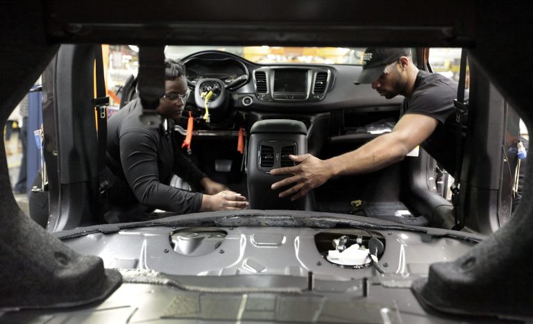 Assembly line workers build a 2015 Chrysler 200 automobile at the Sterling Heights Assembly Plant in Sterling Heights, Mich. (AP Photo/Paul Sancya)