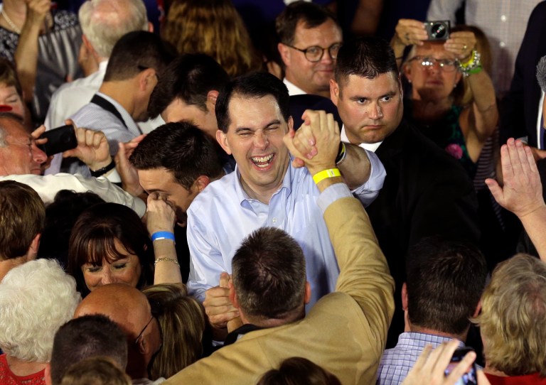 Wisconsin Gov. Scott Walker shakes hands after announcing that he is running for the 2016 Republican presidential nomination at the Waukesha County Expo Center, Monday, July 13, 2015, in Waukesha, Wis. (AP Photo/Nam Y. Huh)