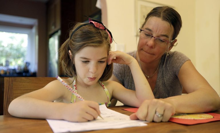 Stacey Jacobson-Francis works on math homework with her 6 year old daughter Luci Wednesday, May 14, 2014, at their home in Berkeley, Calif.Â Gallup rolled out their new measure of parental engagement Tuesday, with the intent of going beyond typical measures of parental involvement in school.Â (AP Photo)