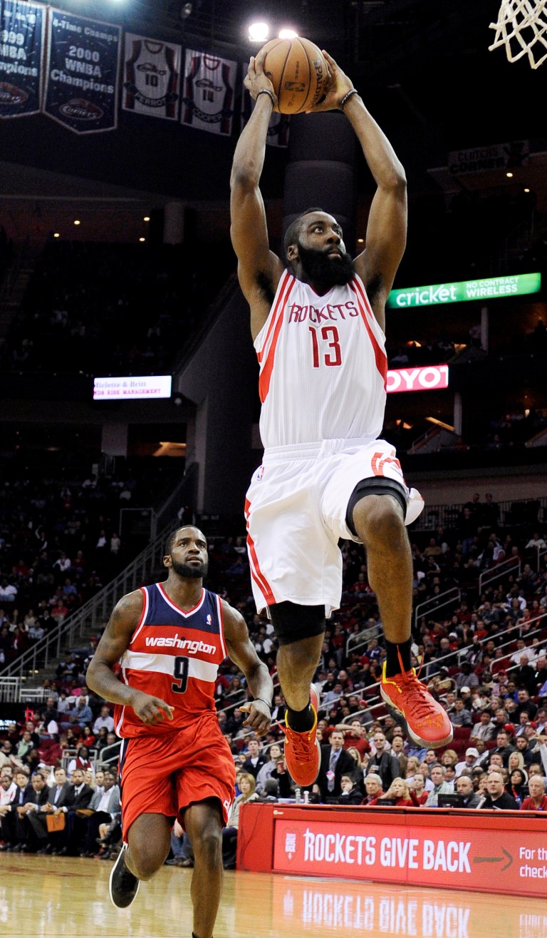   Houston Rockets' James Harden (13) goes to the basket in front of Washington Wizards' Martell Webster (9) in the second half of an NBA basketball game, Wednesday, Dec. 12, 2012, in Houston. The Rockets won 99-93. (AP Photo/Pat Sullivan)  