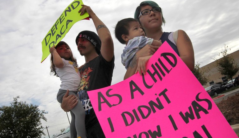 Protesters hold signs in favor of the Obama-era Deferred Action for Childhood Arrivals program, Tuesday, Sept. 5, 2017, in front of the Texas Attorney General's office in Pharr, Texas.