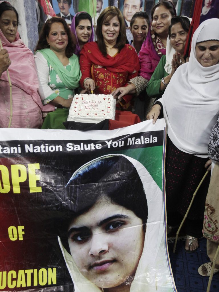 Female supporters of Pakistan People's Party cut a cake to celebrate Nobel Peace Prize winner Malala Yousafzai, who survived the Taliban's attack, at a ceremony in Islamabad, Pakistan, Saturday, Oct. 11, 2014. Taliban attack survivor Malala became the youngest Nobel winner ever as she and Kailash Satyarthi of India won the Nobel Peace Prize on Friday for working to protect children from slavery, extremism and child labor at great risk to their own lives. (AP Photo/Anjum Naveed)