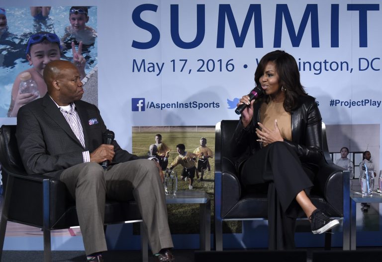 First lady Michelle Obama sits next to her brother Craig Robinson, an ESPN college basketball analyst, as they participate in a discussion at the Aspen Institute's 2016 Project Play Summit at the Newseum in Washington, Tuesday, May 17, 2016. (AP Photo/Susan Walsh)