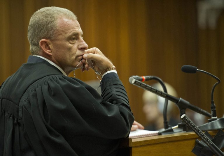State prosecutor, Gerrie Nel, questions Oscar Pistorius in court in Pretoria, South Africa,  Friday, April 11, 2014. Pistorius is charged with the murder of his girlfriend Reeva Steenkamp, on Valentines Day in 2013. (AP Photo/Craig Nieuwenhuizen, Pool)