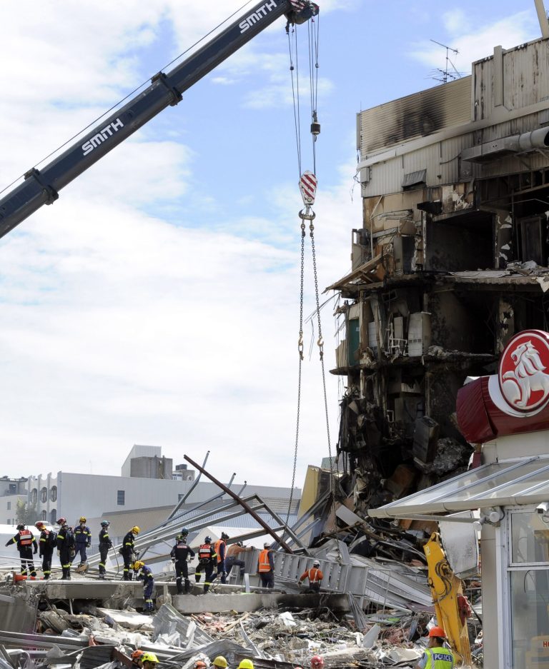   FILE -In this Thursday, Feb. 24, 2011 file photo, search and rescue personnel work at the destroyed CTV building in Christchurch, New Zealand two days after the city was hit by a 6.3 magnitude earthquake, killing 115 people. A final release from the government-ordered commission that spent months investigating the buildings damaged in the quake said Monday, Dec. 10, 2012 that the CTV building was made of weak columns and concrete and did not meet standards when it was built in 1986. The building's designer contested those findings. (AP Photo/Rob Griffith, File)  