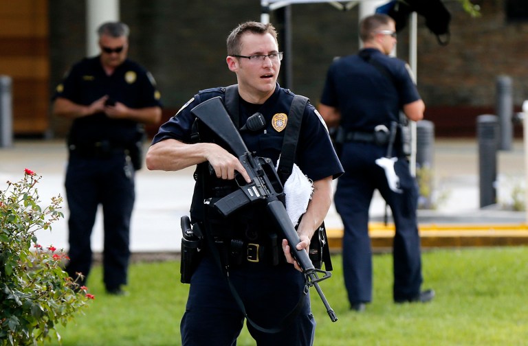 Police guard the emergency room entrance of Our Lady Of The Lake Medical Center, where wounded officers were brought, in Baton Rouge, La. (AP Photo/Gerald Herbert)
