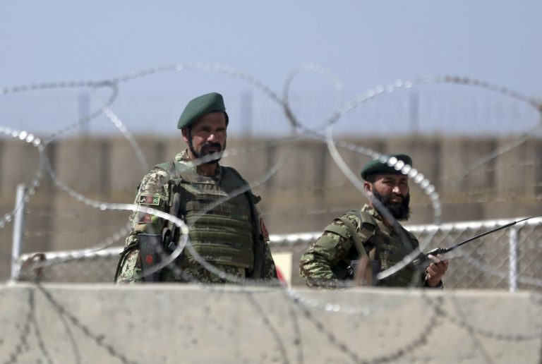Afghanistan National Army soldiers stand guard at a gate of Camp Qargha, west of  Kabul, Afghanistan, Tuesday, Aug. 5, 2014. Earlier in the day, a man dressed in an Afghan army uniform opened fire on foreign troops at the military base, killing a U.S. two-star general and wounding others, among them a German brigadier general and a number of Americans troops, authorities said. (AP Photo/Massoud Hossaini)
