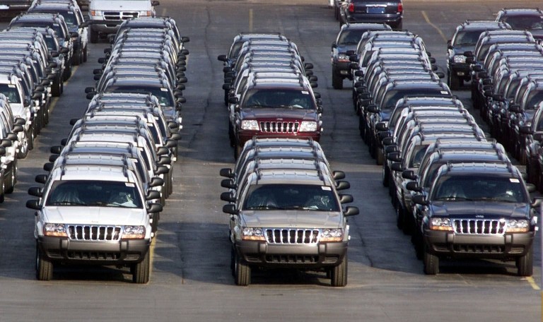   FILE - In this file photo taken Fed. 2, 2001, rows of 2001 Jeep Grand Cherokees are lined up outside the Jefferson North Assembly Plant in Detroit. The National Highway Traffic Safety Administration says on its website Thursday June 14, 2012 that it has added Jeep Liberty and Cherokee SUVs to the investigation. The probe now covers 5.1 million vehicles. The agency says 15 people have died in 26 Grand Cherokee fires. The investigation affects 1993 to 2004 Grand Cherokees. Also covered are 1993-2001 Cherokees and 2002-2007 Liberty's. (AP Photo/Carlos Osorio, File)  