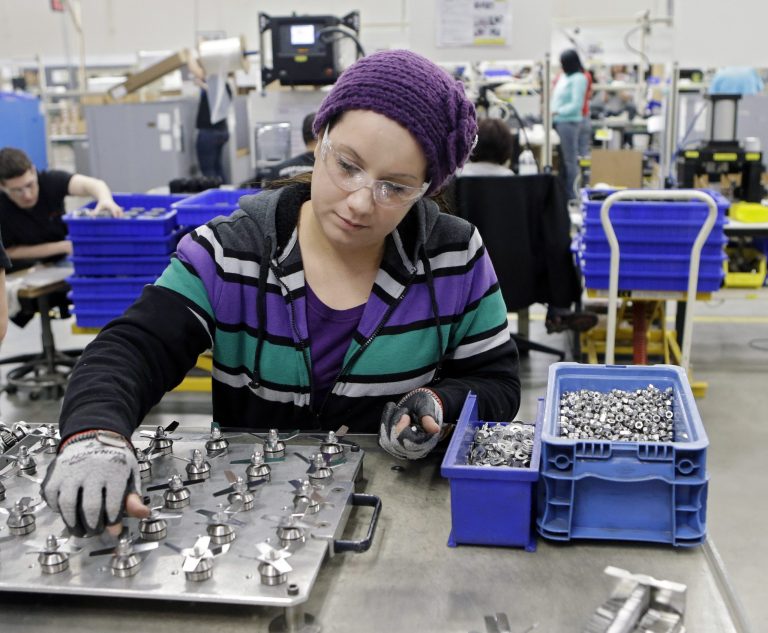 In this April 15, 2014 photo, Evelyn Morales assembles blender blades at the Vitamix manufacturing facility in Strongsville, Ohio. U.S. economic growth should accelerate in the second quarter and remain healthy for the rest of this year, according to a forecast Monday, June 9, 2014 by a group of U.S. business economists. Still, growth for the full year will likely come in lower than they previously estimated.  (AP Photo/Mark Duncan)
