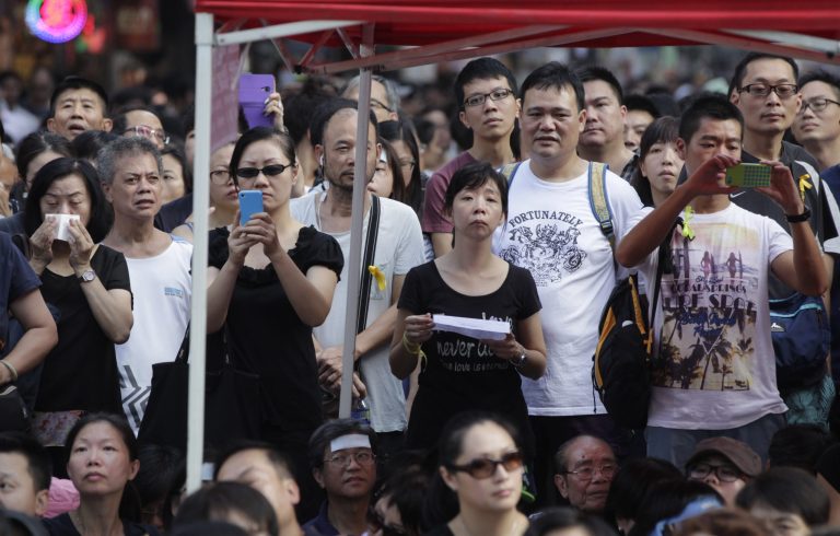 Local residents join a a pro-democracy sit in at a main intersection in the Mongkok district in Hong Kong, Wednesday, Oct. 1, 2014. Student leaders of pro-democracy protests in Hong Kong warned Wednesday that if the territory's leader doesn't resign by the end of Thursday they will step up their actions, including occupying several important government buildings. (AP Photo/Wally Santana)