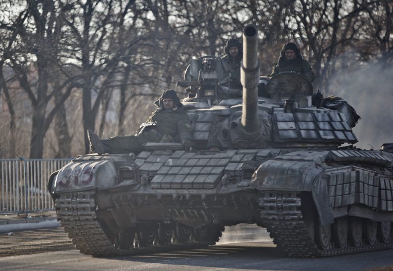Russia-backed rebels ride on a tank outside Luhansk, Ukraine. Poroshenko claims 9,000 Russian troops are deployed inside his country. (AP Photo/Vadim Ghirda)