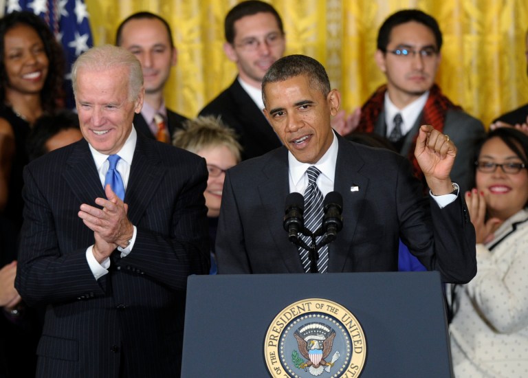 Vice President Joe Biden applauds at left as President Barack Obama urges Congress to take back up comprehensive immigration reform during an event in the East Room of the White House in Washington, Thursday, Oct. 24, 2013. Obama said now that the partial government shutdown is over, Republicans and Democrats should be able to work together to fix what he called 