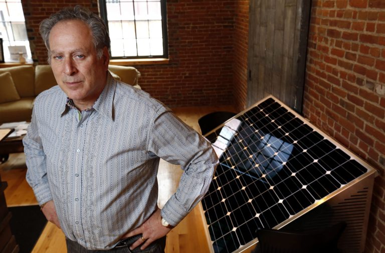 This photo taken Jan. 20, 2014, shows Barry Shear, president of Eagle Point Solar, with one of his company's solar panels inside their Dubuque, Iowa, office.  Eagle Point Solar is involved in a case over solar power going to the Iowa Supreme Court. (AP Photo/The Des Moines Register, Christopher Gannon)