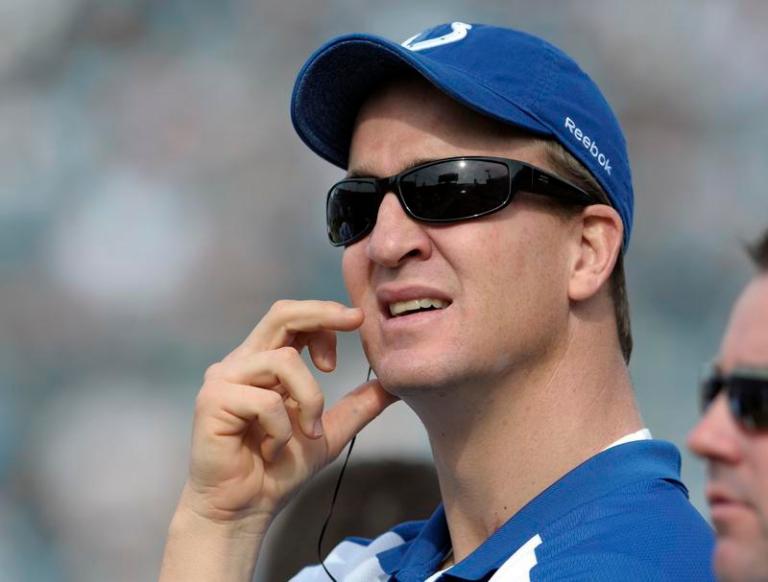 In this Jan. 1, 2012, file photo, Indianapolis Colts quarterback Peyton Manning watches from the sideline during the first half of an NFL football game against the Jacksonville Jaguars in Jacksonville, Fla.
