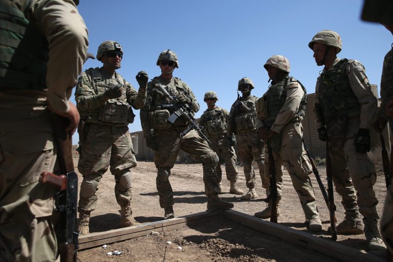 U.S. Army trainers speak with Iraqi Army recruits at a military base on April 12, 2015 in Taji, Iraq. (Photo by John Moore/Getty Images)