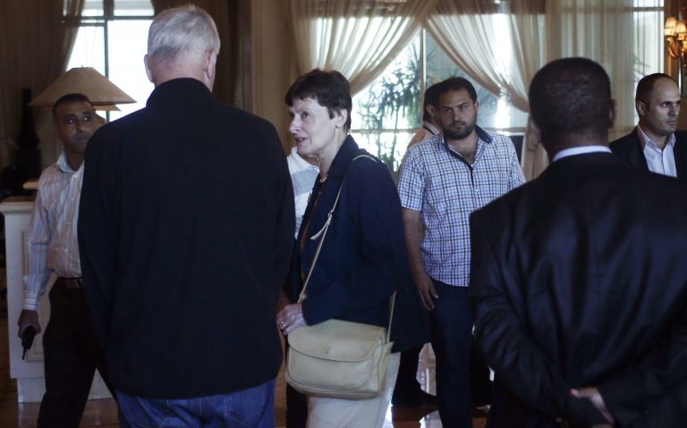  A picture taken through a window shows the United Nations high representative for disarmament affairs, Angela Kane, second left, at a hotel in Damascus, Syria, Saturday, Aug. 24, 2013. The United Nations disarmament chief arrived today to press President Bashar Assad's regime to allow U.N. experts to investigate an alleged chemical weapons attack this week that reportedly killed more than 130 people. Kane who was dispatched by the U.N. secretary-general to push for a speedy investigation into Wednesday's purported attack outside the Syrian capital, did not speak to reporters upon her arrival in Damascus. (AP Photo/Hassan Ammar)  