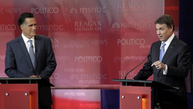 Former Massachusetts Gov. Mitt Romney listens to Texas Gov. Rick Perry during the Republican presidential debate at the Reagan Library.