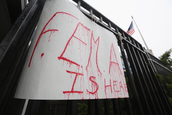 NEW YORK, NY - NOVEMBER 13:   A handwritten FEMA sign drips in the rain where people were waiting on line to receive 1,500 donated coats from New York Cares in the Far Rockaway neighborhood on November 13, 2012 in the Queens borough of New York City. New York Cares started their annual coat drive early this year in order to assist those affected by Superstorm Sandy. They hope to collect 200,000 coats this winter. (Photo by Mario Tama/Getty Images)