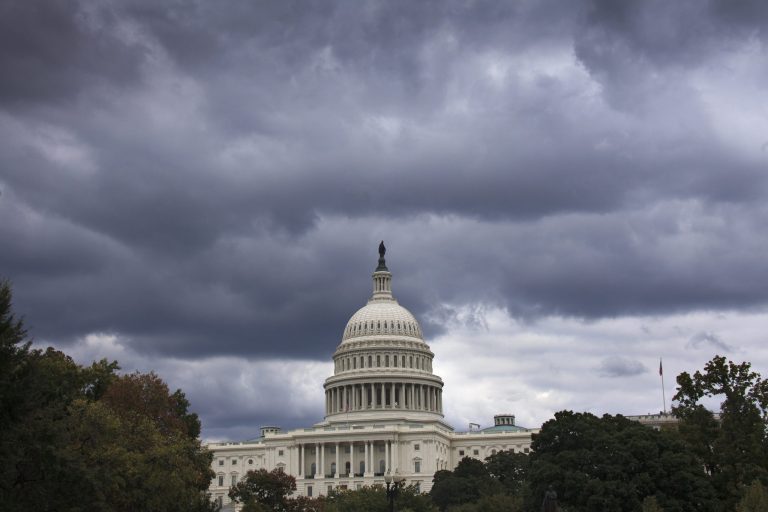 Dark clouds hang over the U.S. Capitol in Washington. A midnight Monday deadline is approaching for Congress to break an impasse over funding the government. (AP/J. Scott Applewhite)