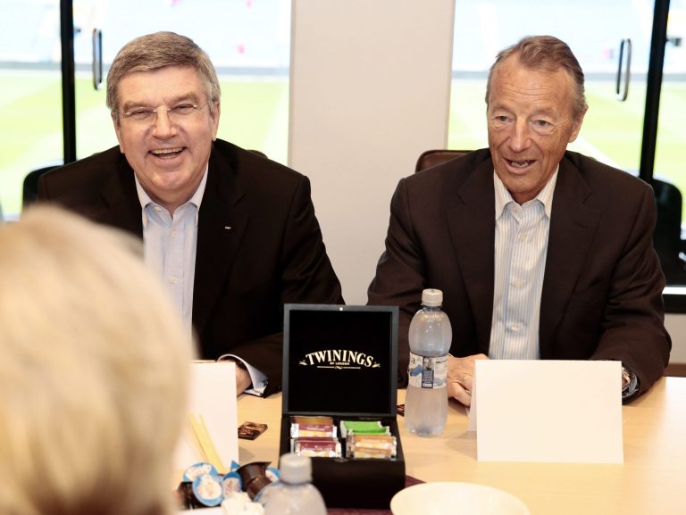 FILE - In this Monday May 19, 2014 fie photo, International Olympic Committee President Thomas Bach. left, smiles  as he sits with Norwegian IOC-member Gerhard Heiberg  during a meeting Norway's Minister of Culture, Thorhild Widvey in Oslo. Oslo said it is dropped its bid for the 2022 Winter Olympics after the Norwegian government declined Wednesday, Oct. 1, 2014 to provide financial backing, a move which leaves just two cities in a race that has been decimated by withdrawals. (AP Photo: Hakon Mosvold Larsen / NTB scanpix, File) NORWAY OUT
