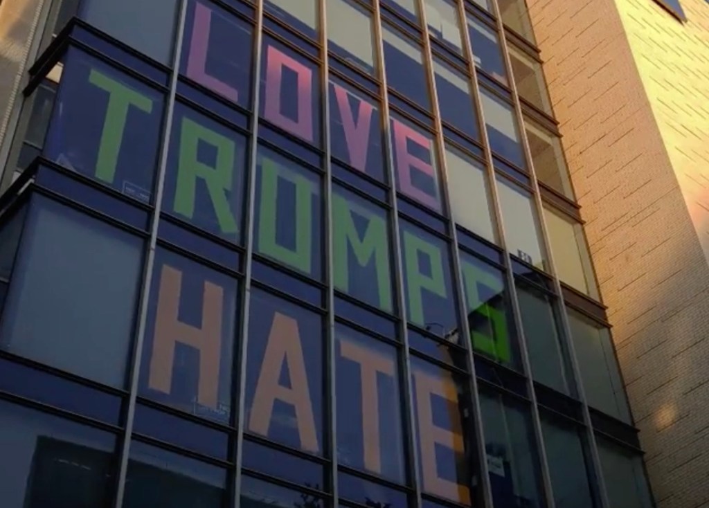 Activists spell out ‘Love Trumps Hate’ on office windows