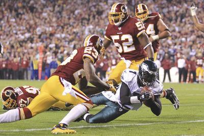 Chris McGrath/Getty Images
Michael Vick, who recently signed a$100 million deal, accounted for six touchdowns in a win over Washington last season.