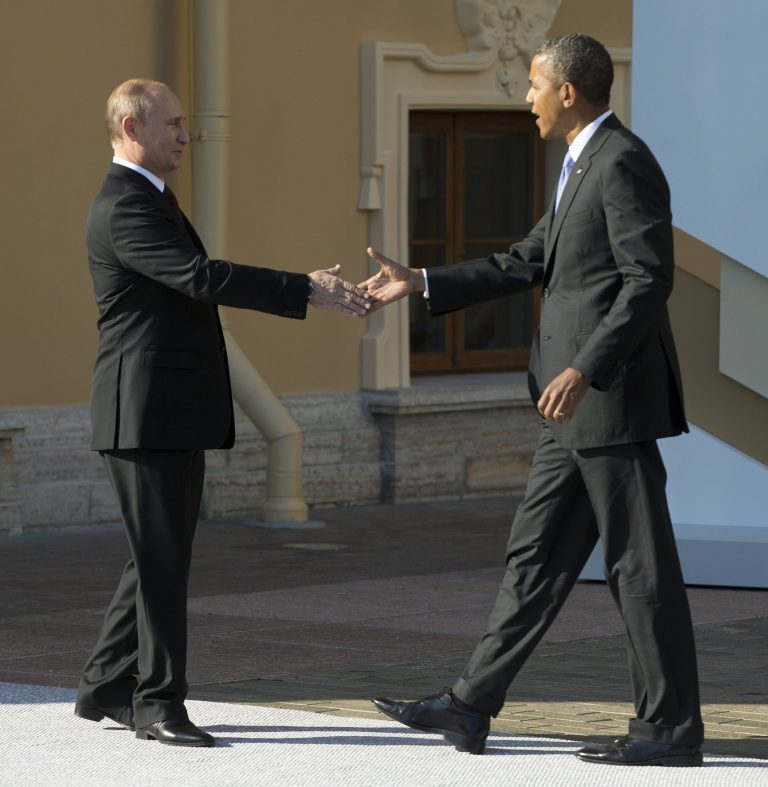   FILE - In this Sept. 5, 2013, President Barack Obama reaches to shakes hands with Russia's President Vladimir Putin during arrivals for the G-20 summit in St. Petersburg, Russia. Obama welcomed an agreement reached with Russia Saturday, Sept. 14, 2013, to secure and destroy Syria's chemical weapons stockpile, but warned that the U.S. remains prepared to act if the attempt at a diplomatic solution fails. 