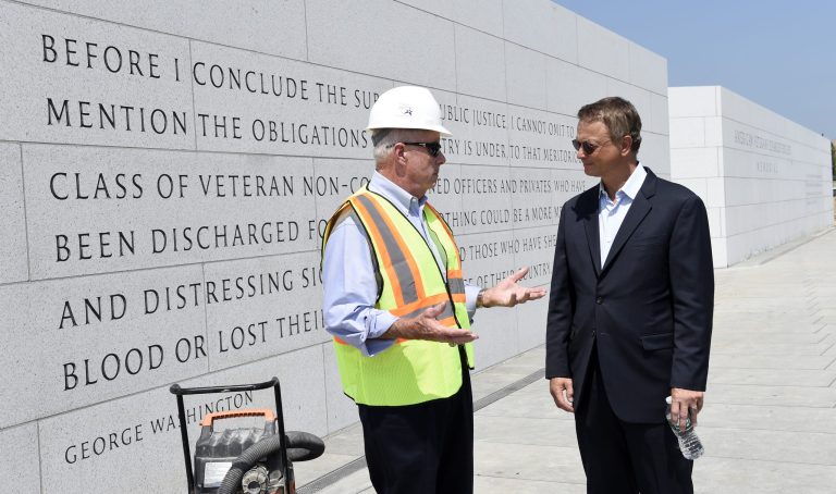 Actor Gary Sinise, right, talks with Arthur H. Wilson, co-founder of the Disabled Veterans' Life Memorial Foundation, Inc., left, as they tour the new American Veterans Disabled for Life Memorial in Washington, Wednesday, Aug. 20, 2014. (AP Photo/Susan Walsh)