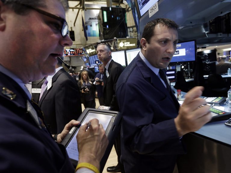Specialist Vincent Surace, right, works at his post on the floor of the New York Stock Exchange, Friday, May 2, 2014. U.S. stock futures are up slightly after the U.S. unemployment rate hit its lowest level in more than five years. The government reported the unemployment rate sank to 6.3 percent. (AP Photo/Richard Drew)