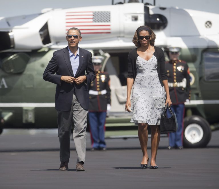 President Barack Obama and first lady Michelle Obama walk across the tarmac before their departure on Air Force One at Homestead Air Reserve Base, Sunday, March 9, 2014, in Homestead, Fla. Obama returned to Washington after spending the weekend in Florida. (AP Photo/Pablo Martinez Monsivais)