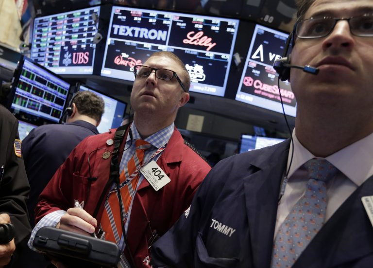 Trader Ryan Falvey, left, works on the floor of the New York Stock Exchange Friday, May 16, 2014. The stock market is little changed in early trading following sharp declines the previous day. (AP Photo/Richard Drew)