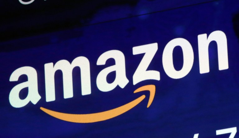 In this Friday, July 27, 2018 file photo, the logo for Amazon is displayed on a screen at the Nasdaq MarketSite. Amazon is facing criticism after its British tax bill fell despite a big jump in sales and profits.