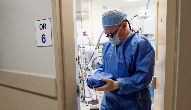 In this photo taken June 28, 2016, Dr. Matthew Cooper carries the kidney donated by Dana Hudson to be transplanted into his wife, Brenda Hudson, in the operating room next door, at MedStar Georgetown University Hospital in Washington.