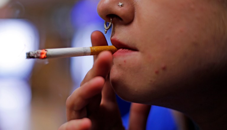 FILE - In this July 17, 2015, file photo, store manager Stephanie Hunt smokes a Marlboro cigarette while posing for photos at a Smoker Friendly shop in Pittsburgh. Altria Group Inc., maker of Marlboro cigarettes, reports financial results on Wednesday, July 27, 2016.